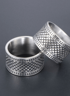 Stylish silver men's rings with intricate patterns on a dark background, perfect for fashion-forward individuals.