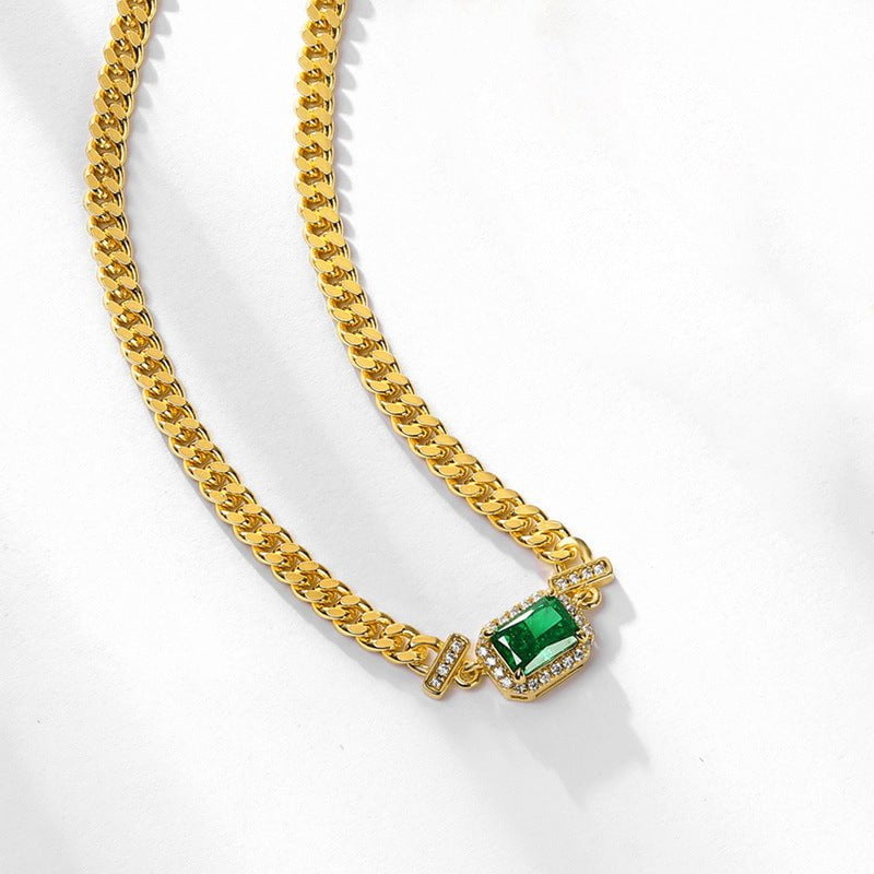 Handcrafted silver jewelry necklace with emerald accent.