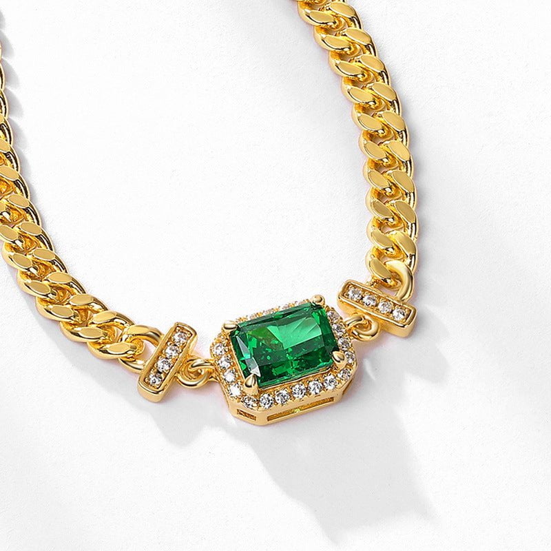 Handcrafted silver necklace with emerald accent, showcasing elegant jewelry craftsmanship.