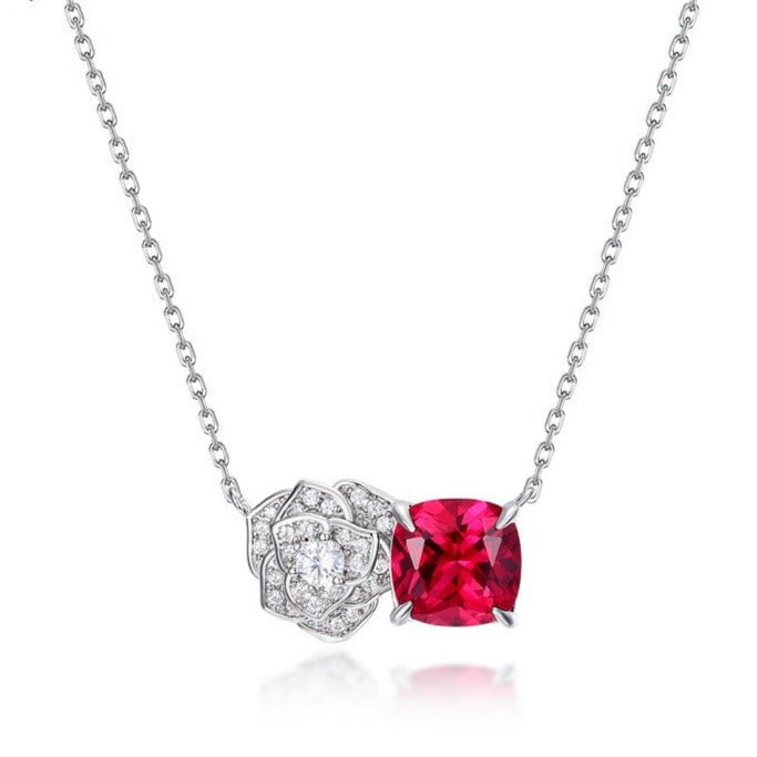 Luminous silver pendant necklace with floral design and red gemstone for women.