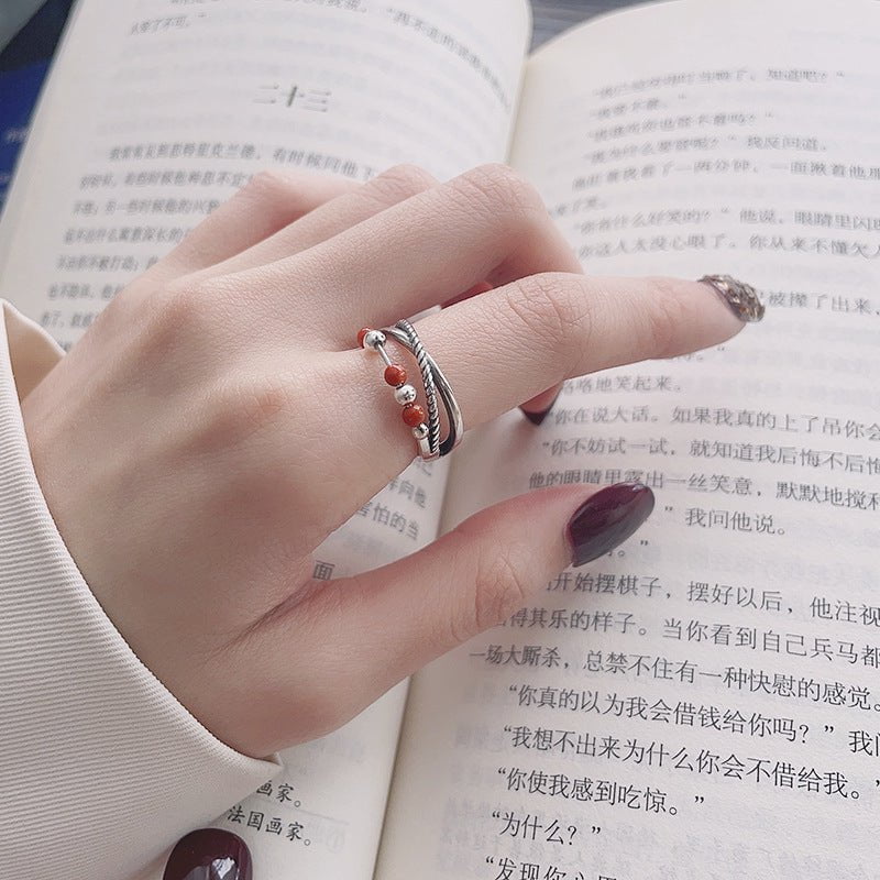 Vintage rotating cross design adjustable silver ring for women on hand, showcasing elegant style and craftsmanship.